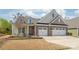 Charming two-story home featuring a brick facade, manicured lawn, and attached two car garage at 5002 Samoa Ridge Dr, Lancaster, SC 29270