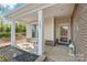 Inviting front porch with elegant white columns, decorative furniture, and a tastefully adorned entrance at 5002 Samoa Ridge Dr, Lancaster, SC 29270