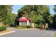 Community guardhouse nestled among lush trees and flowers, adding to the neighborhood's charm at 5002 Samoa Ridge Dr, Lancaster, SC 29270