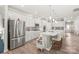 Bright, white kitchen featuring stainless steel appliances and a large island with bar stool seating at 5002 Samoa Ridge Dr, Lancaster, SC 29270