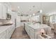 Well-lit kitchen with white cabinets, stainless steel appliances, and a spacious island with counter seating at 5002 Samoa Ridge Dr, Lancaster, SC 29270