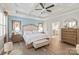 Bright main bedroom with tray ceilings, a comfortable bed, and a view into the ensuite bath at 5002 Samoa Ridge Dr, Lancaster, SC 29270