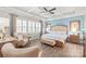 Spacious main bedroom featuring a tray ceiling, large windows, and a seating area at 5002 Samoa Ridge Dr, Lancaster, SC 29270