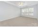 Bright bedroom with neutral carpet and paint, ceiling fan, and large windows at 5306 Prosperity View Dr, Charlotte, NC 28269