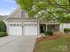 Charming home featuring a two-car garage, complemented by well-maintained landscaping and a cozy, inviting entrance at 5306 Prosperity View Dr, Charlotte, NC 28269