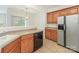 Bright kitchen featuring stainless steel refrigerator, wooden cabinets, and functional layout for cooking at 5306 Prosperity View Dr, Charlotte, NC 28269