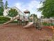 Community playground featuring slides, climbing structures, and a mulch ground cover, perfect for outdoor fun and recreation at 5306 Prosperity View Dr, Charlotte, NC 28269