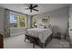 Inviting bedroom featuring a large window, ceiling fan, and a cozy bed with decorative pillows at 536 Spring Landing Dr, Rock Hill, SC 29730