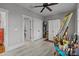 Bright bedroom featuring light gray walls, ceiling fan, and an open doorway with white trim at 536 Spring Landing Dr, Rock Hill, SC 29730