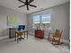 Comfortable bedroom featuring carpet, a ceiling fan, a desk, and a window overlooking the neighborhood at 536 Spring Landing Dr, Rock Hill, SC 29730