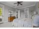 Bright bedroom features a patterned bedspread, ceiling fan, and doorway to the outside at 536 Spring Landing Dr, Rock Hill, SC 29730
