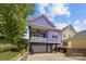 Charming two-story purple home with a spacious balcony and a convenient drive-under garage at 536 Spring Landing Dr, Rock Hill, SC 29730