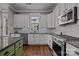 Clean kitchen with stainless steel appliances, island, white cabinets, light countertops, and hardwood floors at 536 Spring Landing Dr, Rock Hill, SC 29730