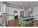 Modern kitchen featuring stainless steel appliances, an island with barstool seating, white cabinets and hardwood floors at 536 Spring Landing Dr, Rock Hill, SC 29730