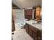 Upstairs bathroom with wood paneling, a shower, and a vanity with storage at 550 Camrose Ne Cir, Concord, NC 28025
