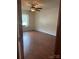 Cozy bedroom featuring wood-look laminate flooring and a ceiling fan at 550 Camrose Ne Cir, Concord, NC 28025
