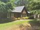 Charming single-story home with wood siding, manicured landscaping and lush green lawn in a peaceful setting at 550 Camrose Ne Cir, Concord, NC 28025