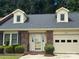 Charming single-Gathering home featuring a brick facade, dormer windows, and an attached garage at 550 Camrose Ne Cir, Concord, NC 28025