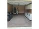 Spacious garage area with ample storage including cabinets and utility sink at 550 Camrose Ne Cir, Concord, NC 28025