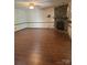 Open living room with a stone fireplace, wood-look laminate flooring, and natural light at 550 Camrose Ne Cir, Concord, NC 28025