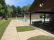 Community pool area with ample seating, picnic tables, covered pavilion and fenced in pool area at 550 Camrose Ne Cir, Concord, NC 28025