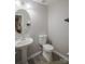 Half bathroom featuring a pedestal sink and a round mirror at 585 Gentle Breeze Ln, Rock Hill, SC 29730