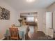 Cozy dining room with wood table and chairs, flowing into the living room area at 585 Gentle Breeze Ln, Rock Hill, SC 29730
