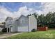 Side view of light gray two-story house with a two-car garage and green grass at 585 Gentle Breeze Ln, Rock Hill, SC 29730