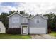 Charming two-story home with light gray siding, an attached garage, and manicured landscaping at 585 Gentle Breeze Ln, Rock Hill, SC 29730
