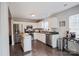 Open kitchen featuring white cabinets, stainless steel appliances, and a functional rolling island at 585 Gentle Breeze Ln, Rock Hill, SC 29730