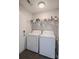 Functional laundry room with a white washer and dryer, and ample storage space at 585 Gentle Breeze Ln, Rock Hill, SC 29730