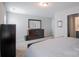 Bright main bedroom featuring soft carpet and a dark wood dresser with a large mirror at 585 Gentle Breeze Ln, Rock Hill, SC 29730