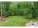 Spacious backyard with lush green grass and a fire pit, perfect for outdoor activities and relaxation at 625 S Magnolia St, Mooresville, NC 28115