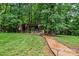 Spacious backyard featuring a custom outdoor bar area and lush greenery at 625 S Magnolia St, Mooresville, NC 28115