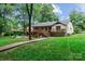 Beautiful backyard featuring a sprawling lawn, wooden deck, and patio areas ideal for outdoor activities at 625 S Magnolia St, Mooresville, NC 28115
