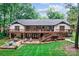 Expansive backyard with large wooden deck, stairs, and outdoor seating areas perfect for entertaining at 625 S Magnolia St, Mooresville, NC 28115