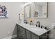Bright bathroom boasts double sinks with granite counters, sleek fixtures, and contemporary mirrors for a spa-like feel at 625 S Magnolia St, Mooresville, NC 28115