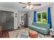Bright bedroom featuring a futon, ceiling fan, and view of the outdoors at 625 S Magnolia St, Mooresville, NC 28115