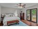 Relaxing bedroom showcasing a comfortable bed, natural light, a ceiling fan, and an exit to the outdoor deck at 625 S Magnolia St, Mooresville, NC 28115