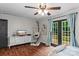 Relaxing bedroom with french doors to deck, ceiling fan, wood floors, and neutral tones at 625 S Magnolia St, Mooresville, NC 28115
