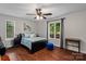 Bedroom with a large window, ceiling fan, and hardwood flooring at 625 S Magnolia St, Mooresville, NC 28115