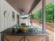 Covered deck bar, perfect for entertaining, with glasses and a decanter at 625 S Magnolia St, Mooresville, NC 28115