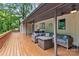 Covered deck with outdoor seating, a ceiling fan, and a grill for outdoor entertaining at 625 S Magnolia St, Mooresville, NC 28115