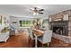 Open-concept dining area with a fireplace, hardwood floors, and comfortable seating at 625 S Magnolia St, Mooresville, NC 28115