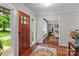 Home foyer featuring a wood door, hardwood floors, and natural light at 625 S Magnolia St, Mooresville, NC 28115