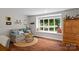Bright living room with hardwood floors, cozy seating, and a large picture window at 625 S Magnolia St, Mooresville, NC 28115