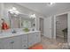 Bright bathroom featuring double sinks, a large mirror, and an adjacent shower and bathtub at 635 Timberlane Trl, Salisbury, NC 28147
