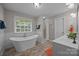 Elegant bathroom with a standalone tub, walk-in shower, and white vanity at 635 Timberlane Trl, Salisbury, NC 28147