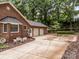 Spacious brick home with a large driveway leading to a three-car garage, surrounded by mature trees at 635 Timberlane Trl, Salisbury, NC 28147
