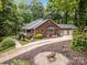 Charming red brick home with a well-manicured front yard, mature trees, and a three car garage at 635 Timberlane Trl, Salisbury, NC 28147